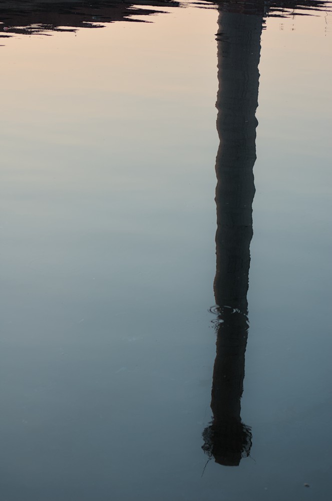 Chimney reflected at harbor
