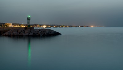 Green lighthouse at night