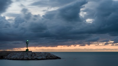 Green lighthouse at dusk
