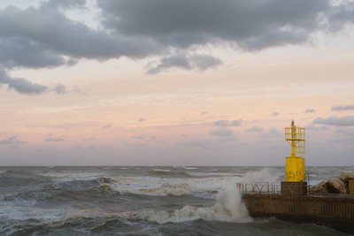 Yellow lighthouse with waves