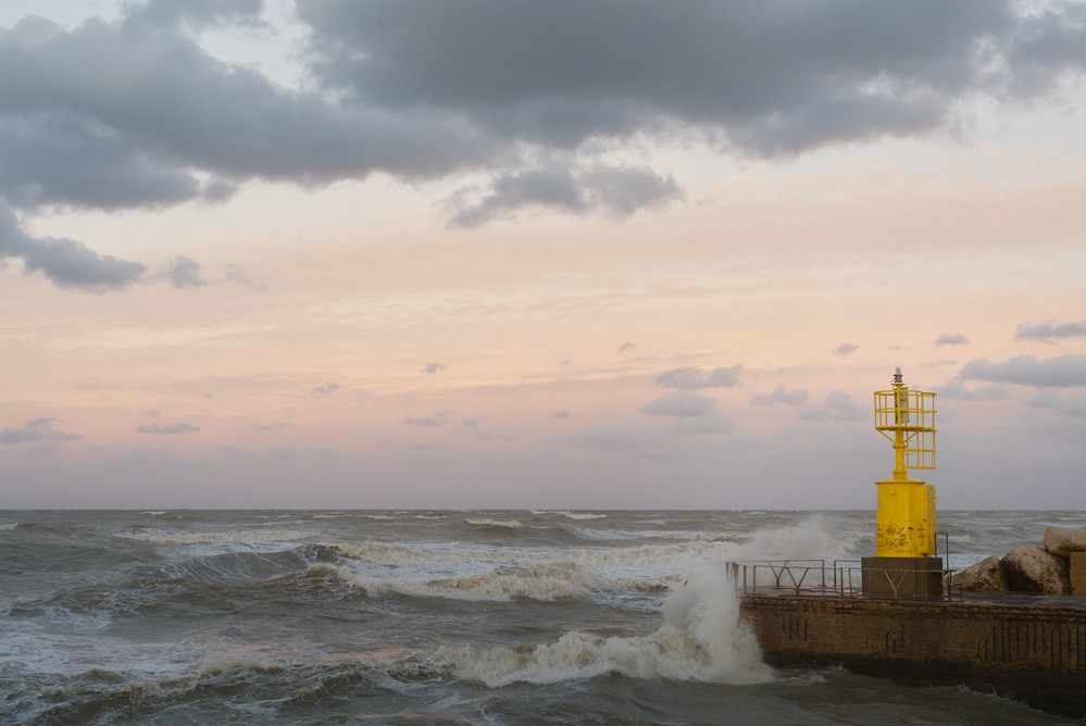 Yellow lighthouse with waves