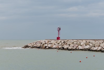 Red lighthouse and orange buoys
