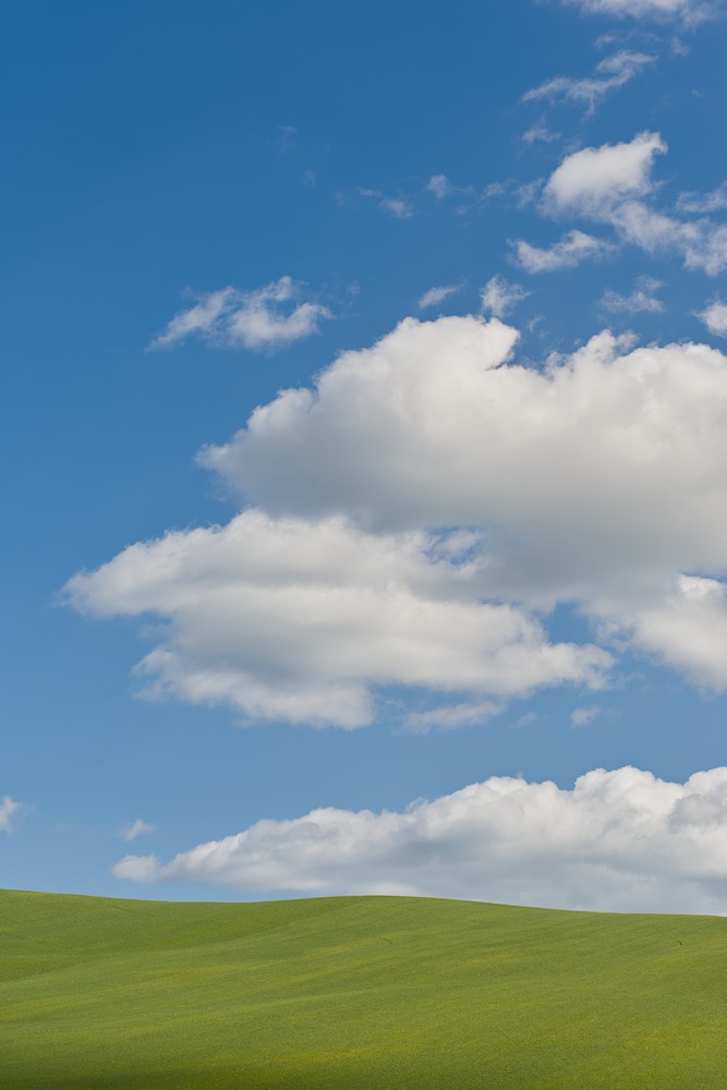 Green hill with clouds