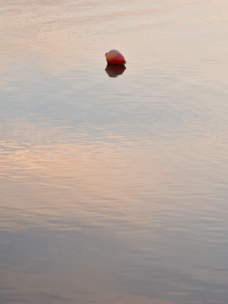 Yellow orange buoy at dusk