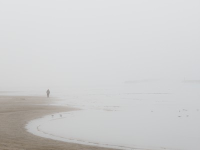 Walking on the beach in winter with the fog