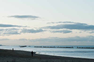 Walking on the beach in winter at dusk