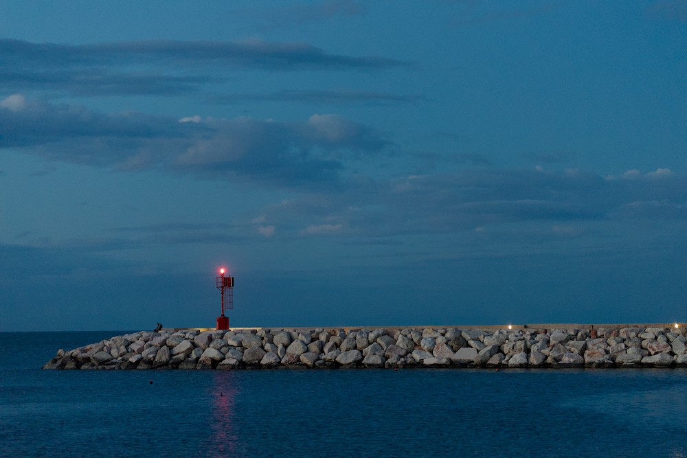 Watching the sea at the red lighthouse