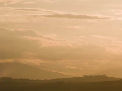 Sunset on the hills through the haze