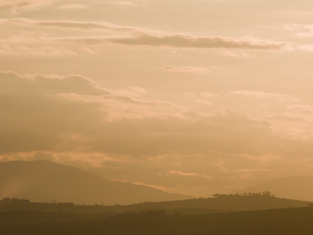 Sunset on the hills through the haze