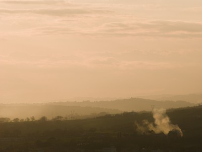 Sunset on the hills through the haze