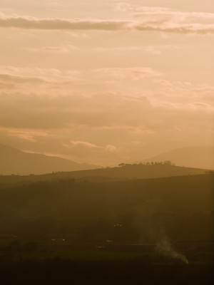 Sunset on the hills through the haze