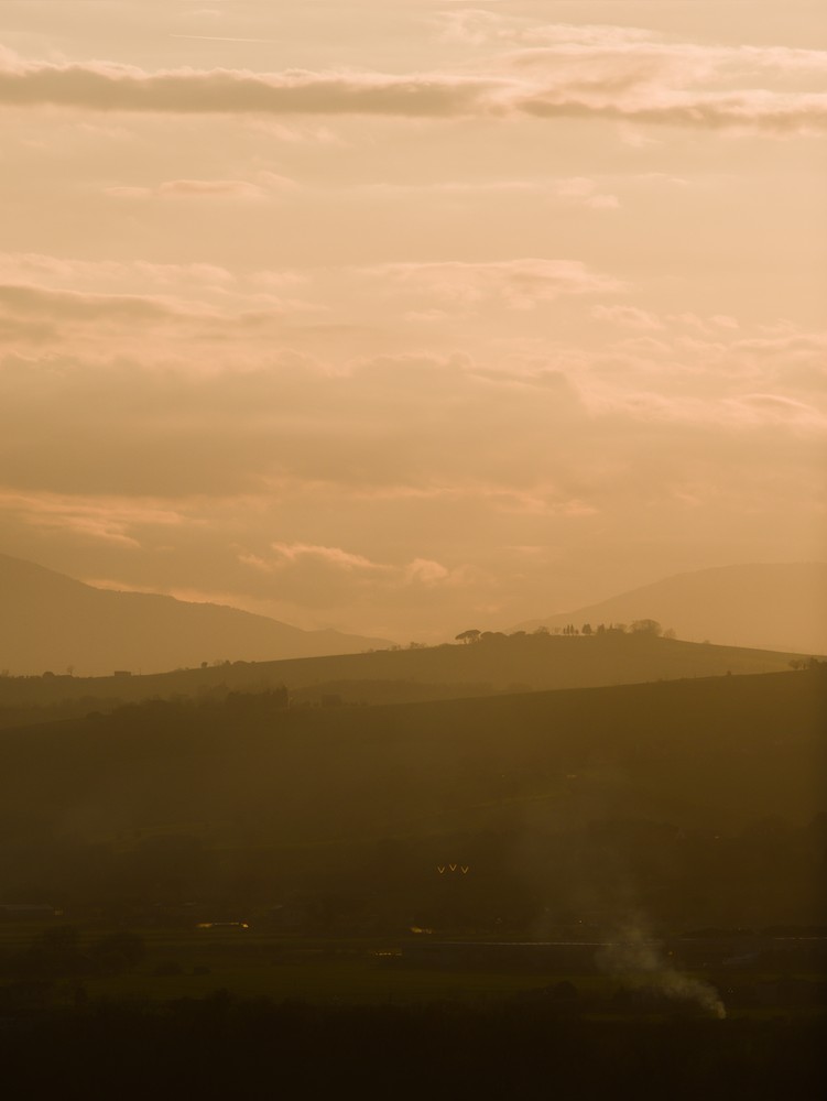 Sunset on the hills through the haze