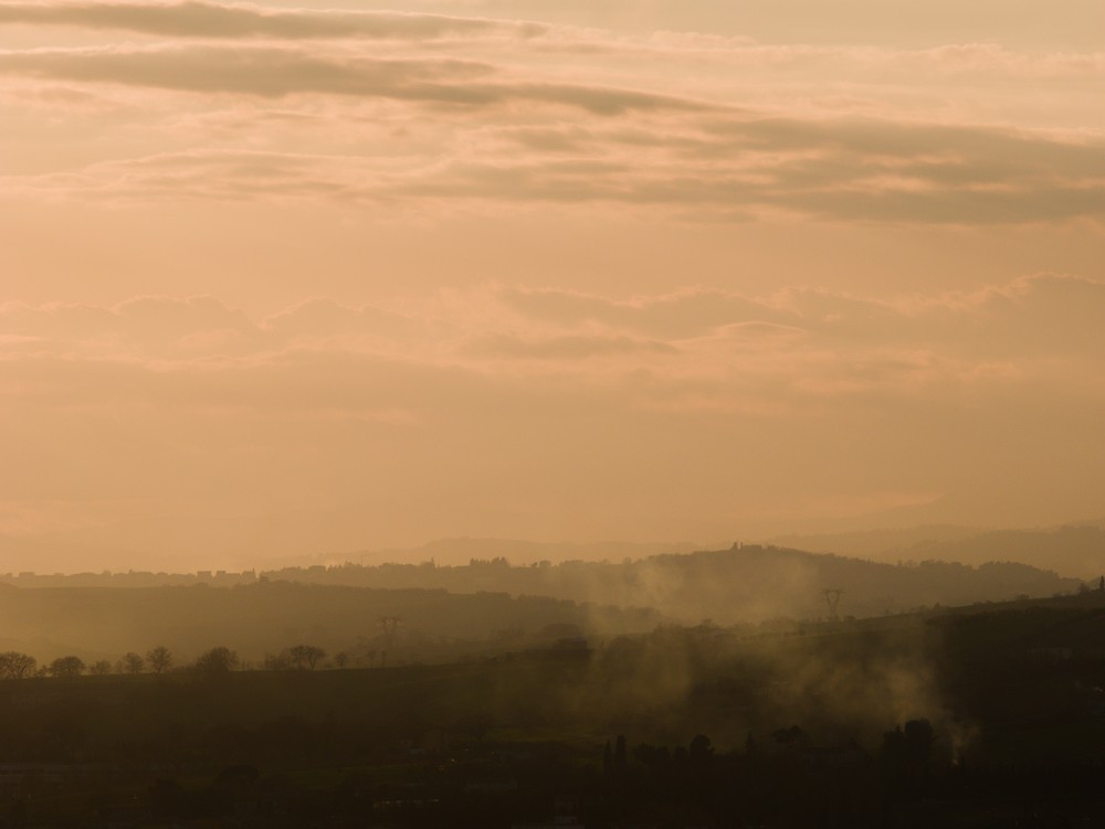 Sunset on the hills through the haze