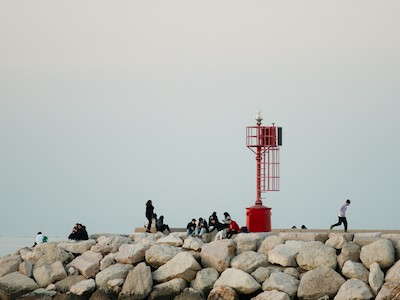 Sitting on the rocks at the red lightouse