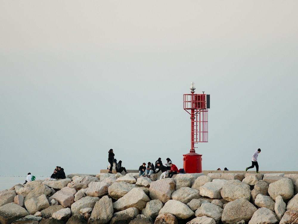Sitting on the rocks at the red lightouse