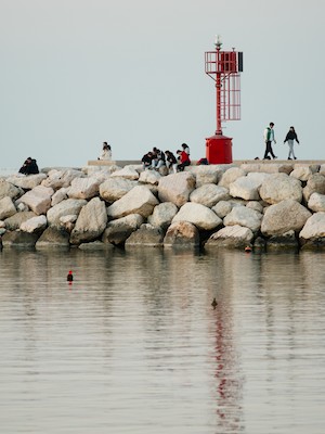 Sitting on the rocks at the red lightouse
