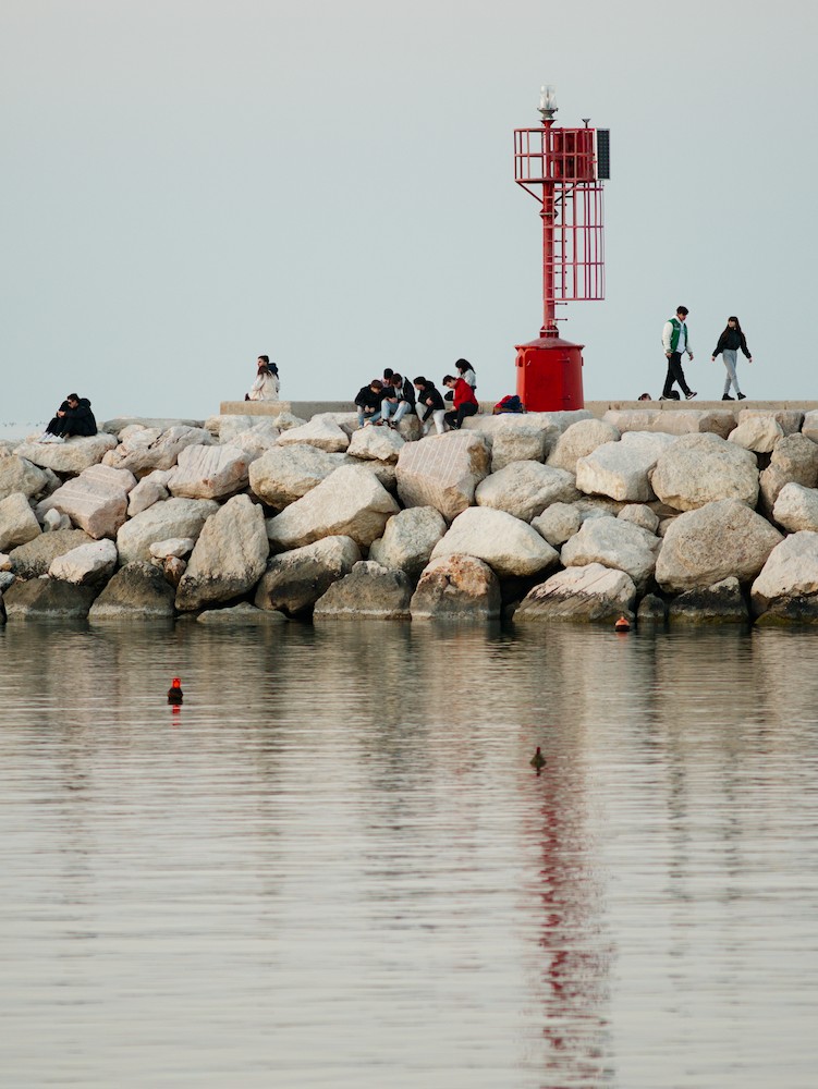 Sitting on the rocks at the red lightouse