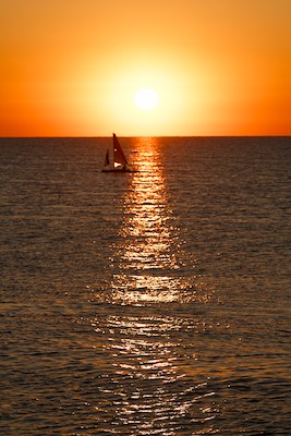 Sunrise with a sail boat