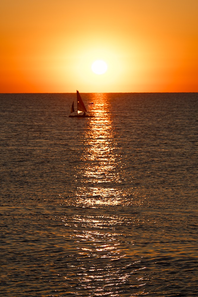 Sunrise with a sail boat