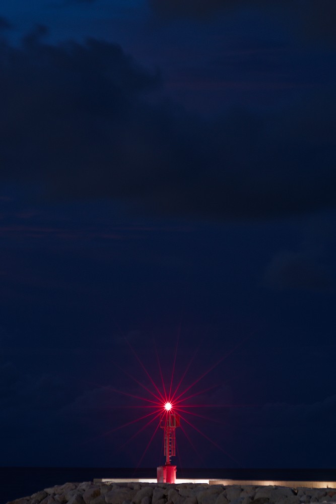 Red lighthouse at night