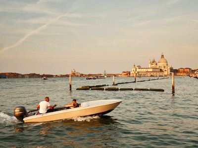Passing boat at sunrise, with Punta della Dogana on the background