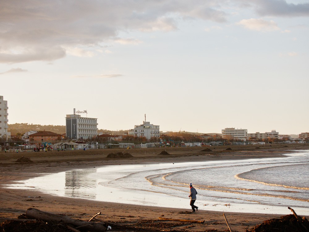 Running on the beach in winter at sunset