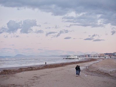 Walking on the beach in winter at dusk