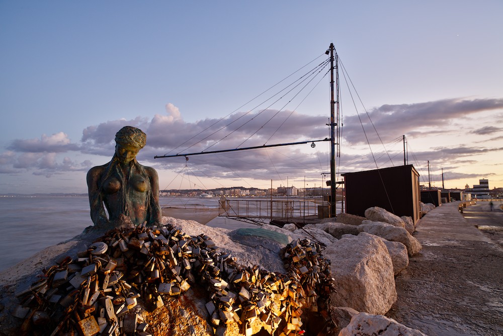 Sirenetta stature at the harbor at dusk