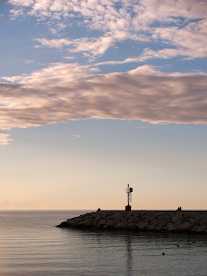 Watching the horizon at the harbor at sunset