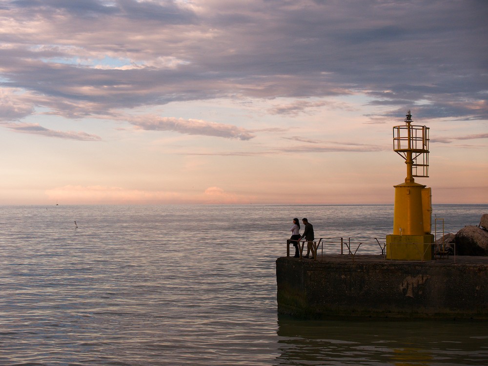 Watching the horizon at the harbor at sunset