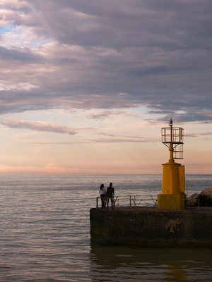 Watching the horizon at the harbor at sunset