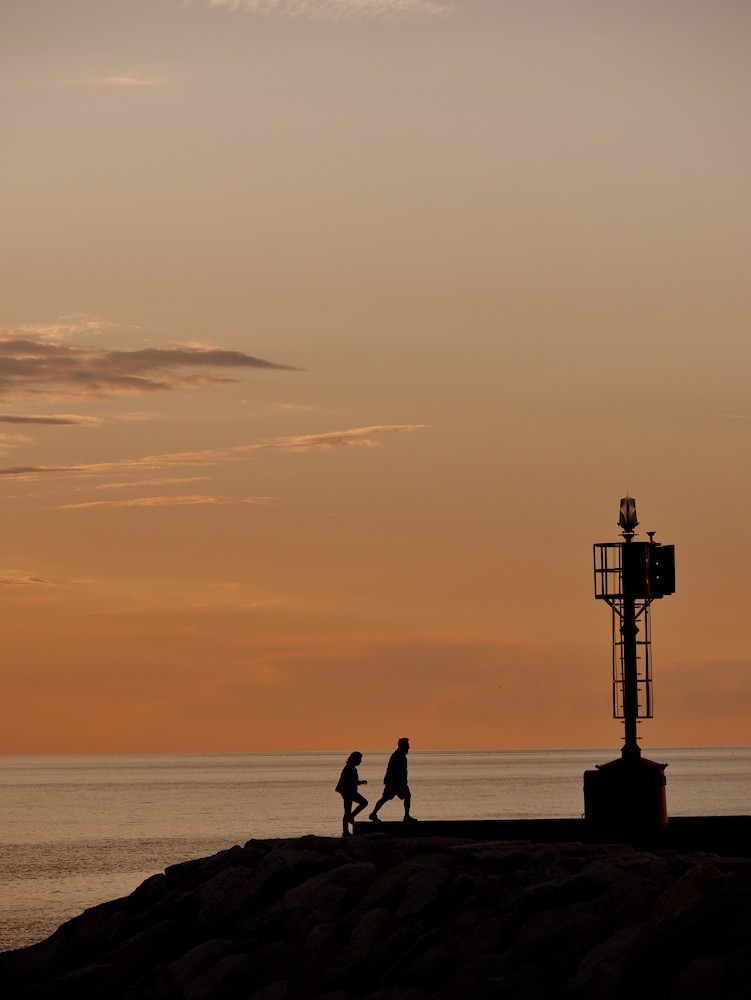 Walking at the harbor at sunset