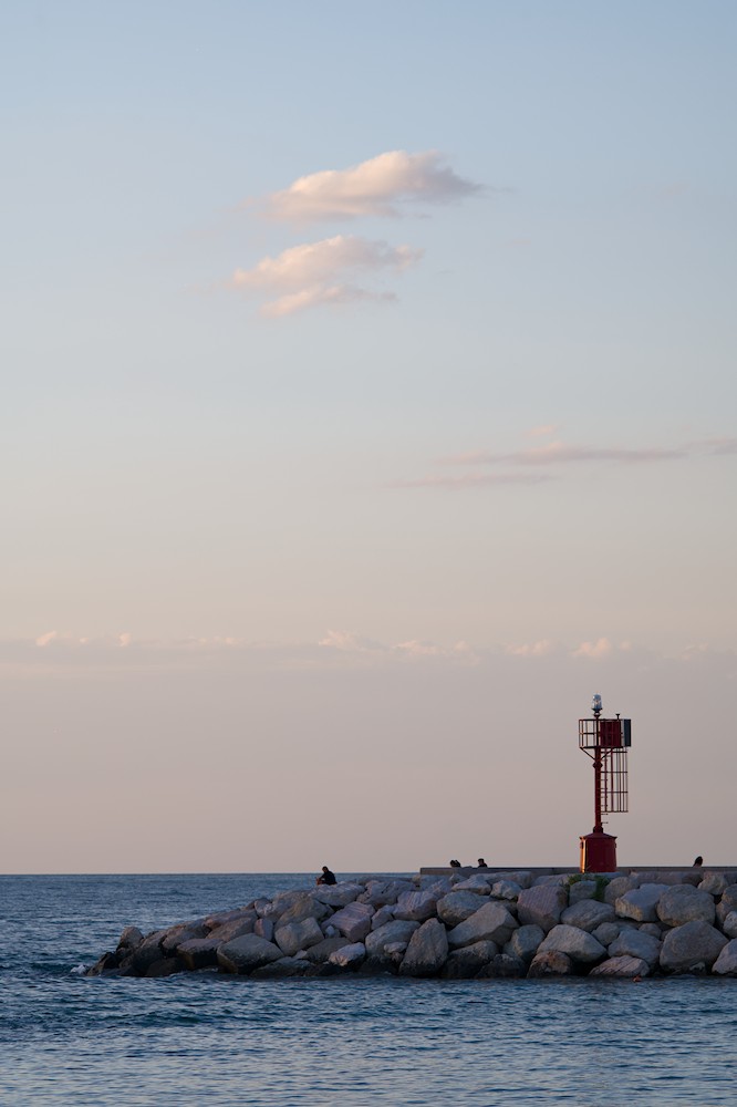 Watching the horizon at the harbor at sunset