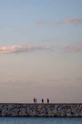 Watching the horizon at the harbor at sunset