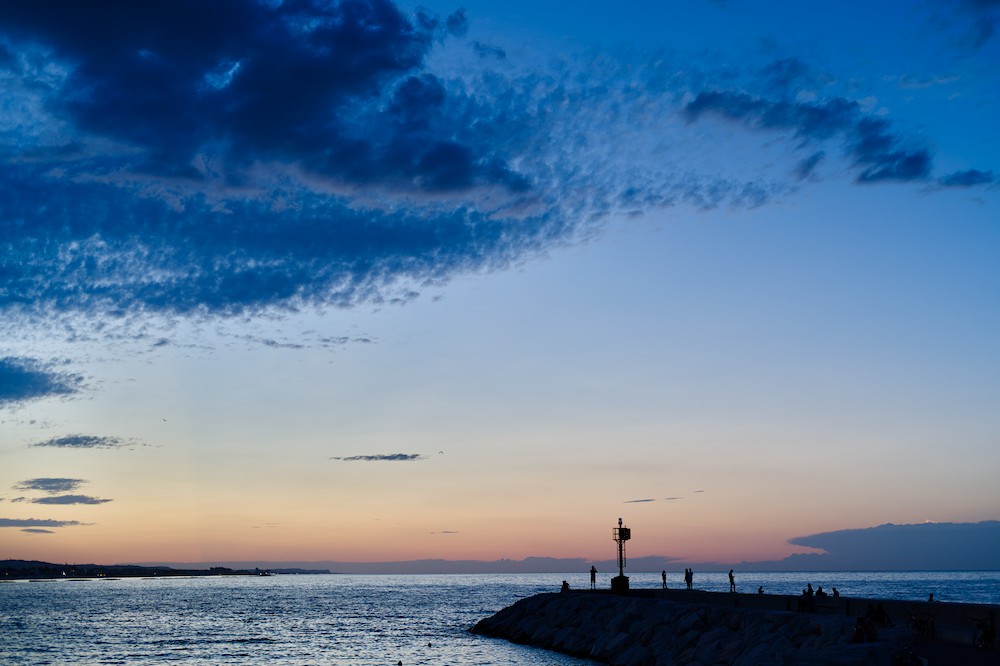 Watching the horizon at the harbor at dusk