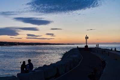 Watching the horizon at the harbor at dusk