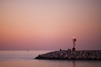 Watching the horizon at the harbor at sunset