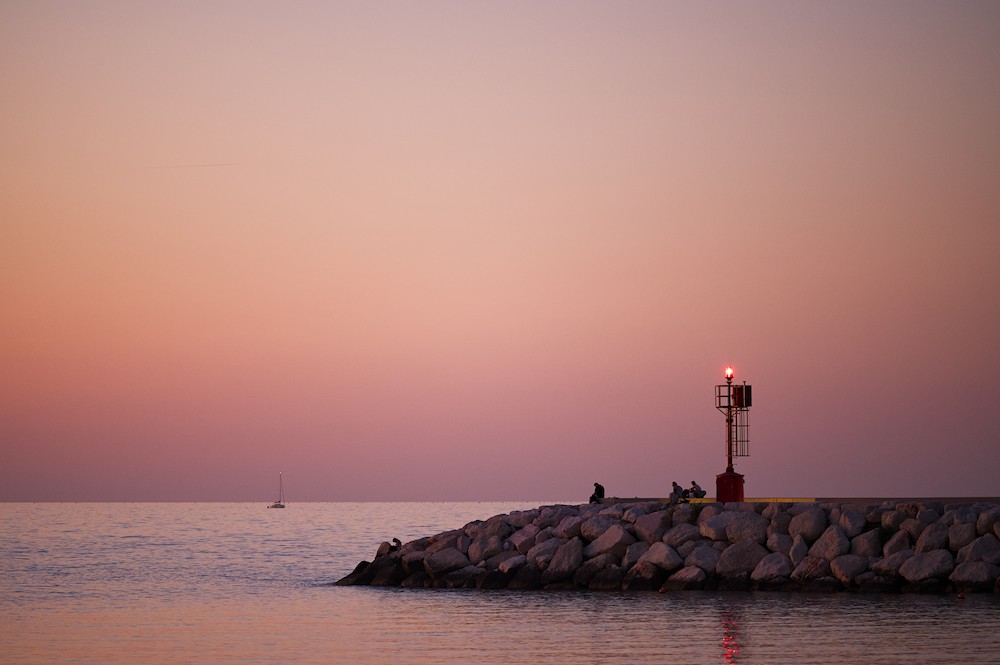 Watching the horizon at the harbor at sunset