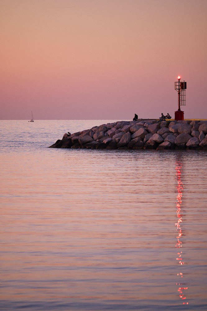 Watching the horizon at the harbor at sunset